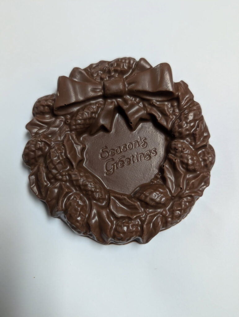 chocolate wreath that says seasons greetings